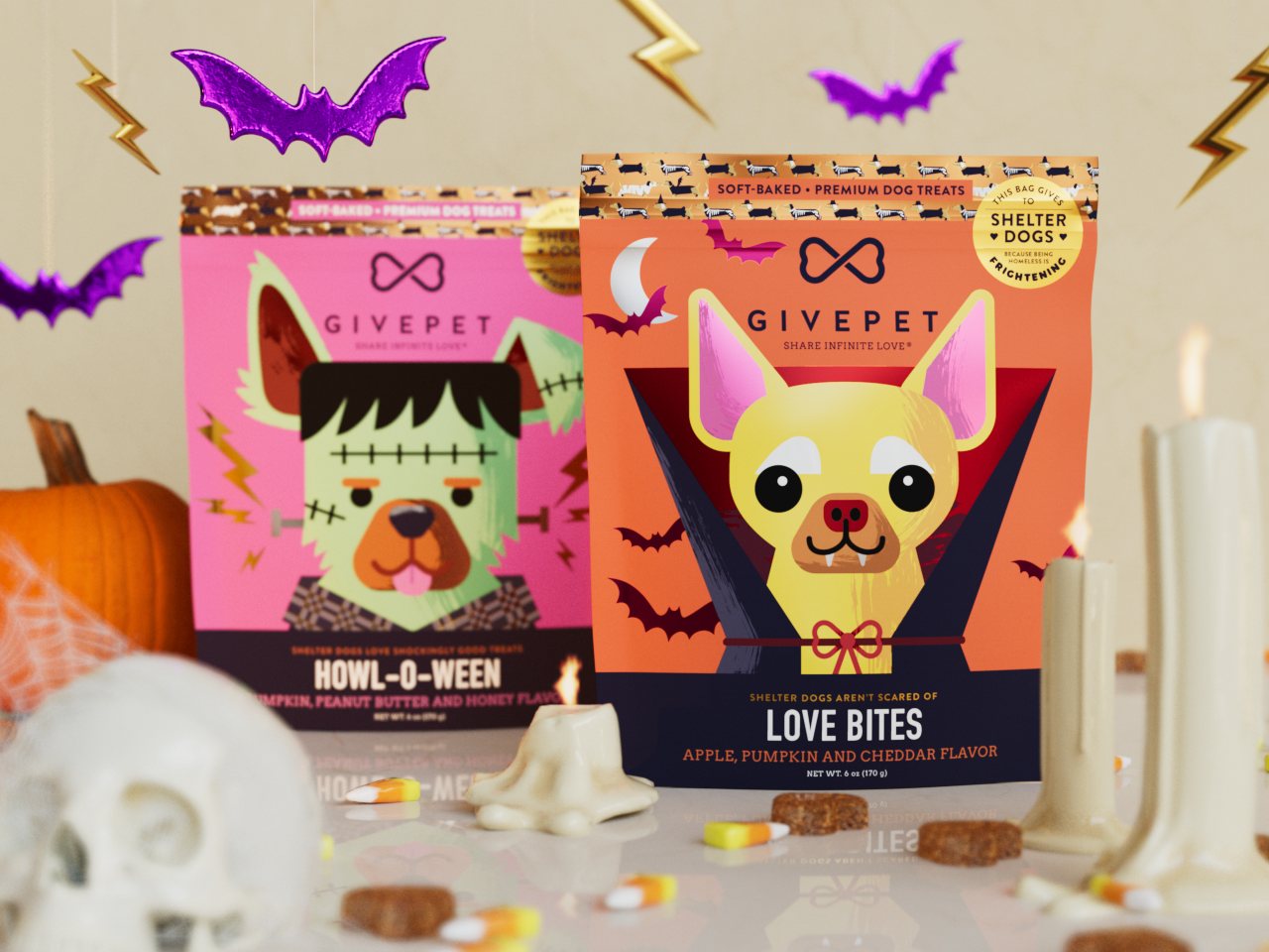 Howl-O-Ween and Love Bites pouches on a table with a skull, candles, bats and a pumpkin