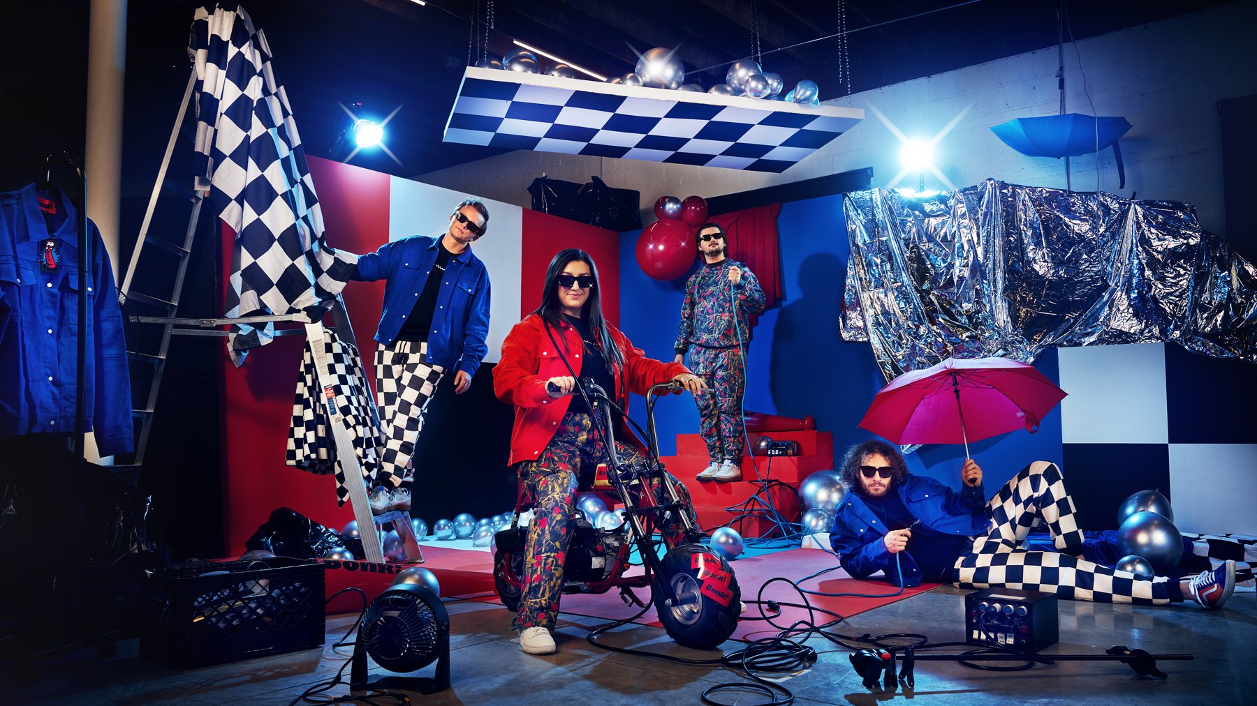 Bonk Supply campaign with four people in patterned clothing and colorful props